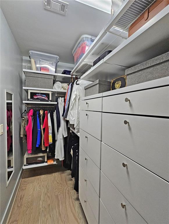 4561 Olde Perimeter Way, Unit 1002 Atlanta, GA 30346 - Photo 15 of 43 a view of walk in closet with clothes