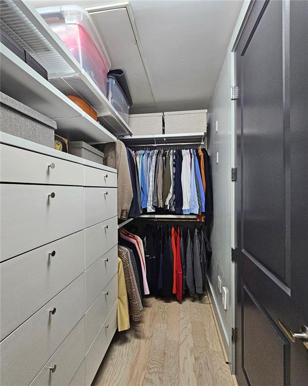 4561 Olde Perimeter Way, Unit 1002 Atlanta, GA 30346 - Photo 16 of 43 a view of walk in closet with clothes