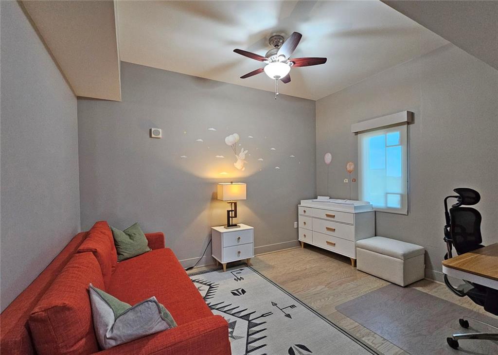 4561 Olde Perimeter Way, Unit 1002 Atlanta, GA 30346 - Photo 17 of 43 a bedroom with furniture and a chandelier fan