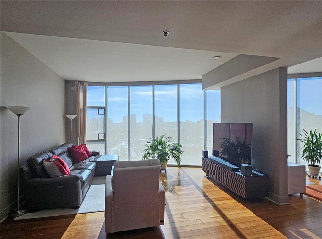 4561 Olde Perimeter Way, Unit 1002 Atlanta, GA 30346 - Photo 6 of 43 a living room with furniture plant and a large window
