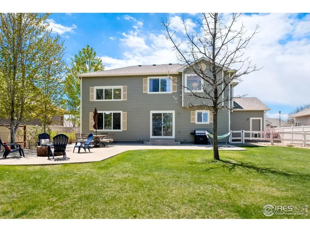 a view of a house with a yard patio and fire pit