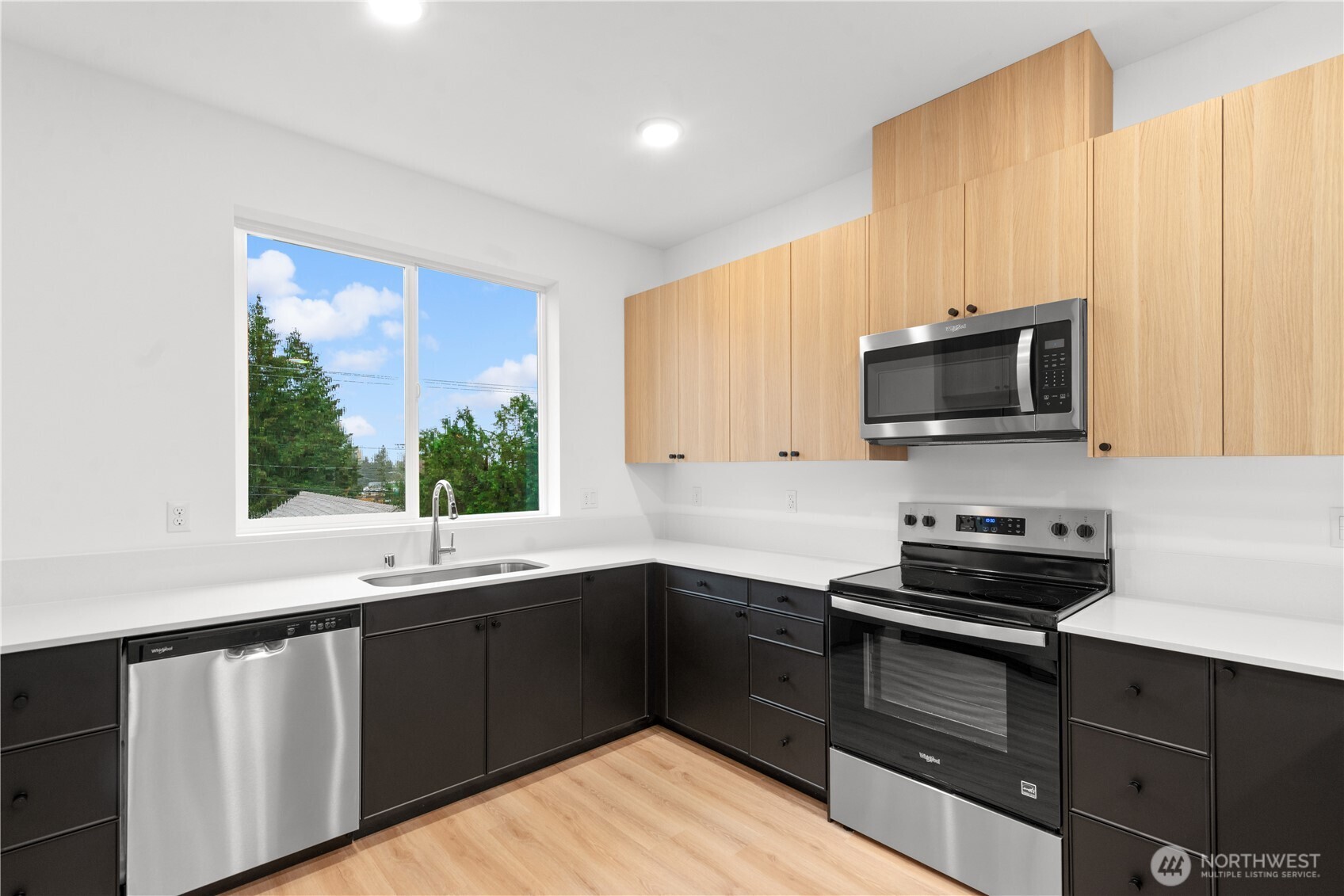 1421 Southwest 111th Lane Seattle, WA 98146 - Photo 15 of 35 a kitchen with a sink stove and microwave
