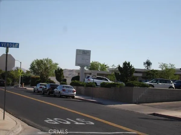 a view of parked cars in front of house
