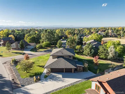 an aerial view of a house with swimming pool patio and outdoor seating