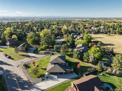 an aerial view of residential houses with outdoor space and swimming pool