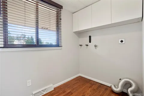 a bathroom with a granite countertop sink toilet a mirror and shower