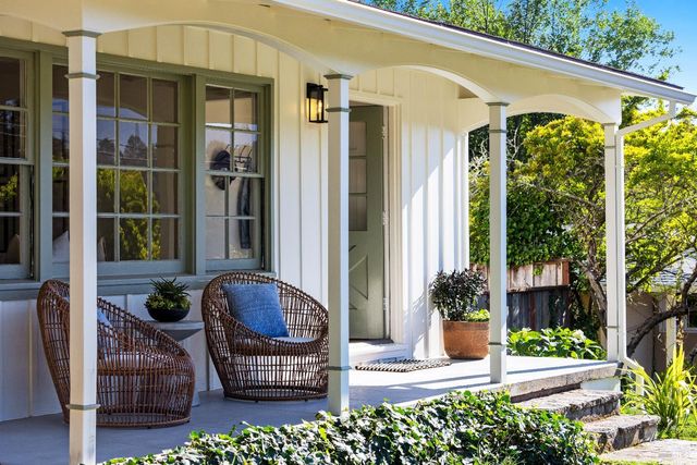 a front view of a house with outdoor seating and plants