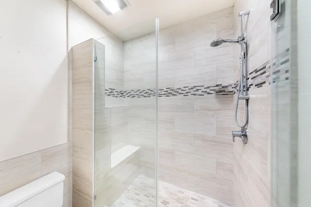 a utility room with fridge and window