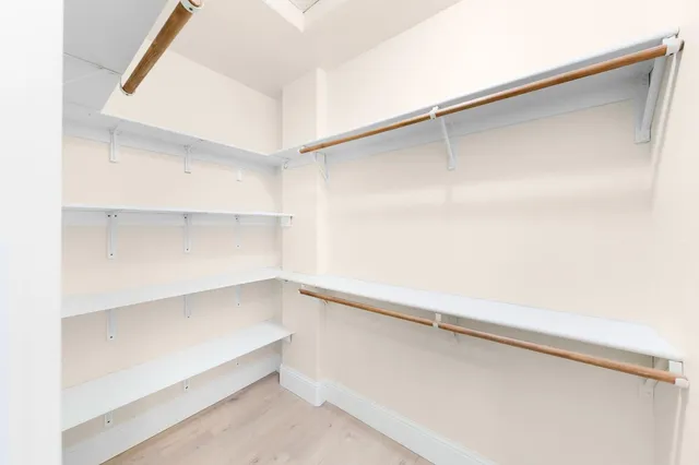a view of a patio with table and chairs potted plants with wooden floor and fence