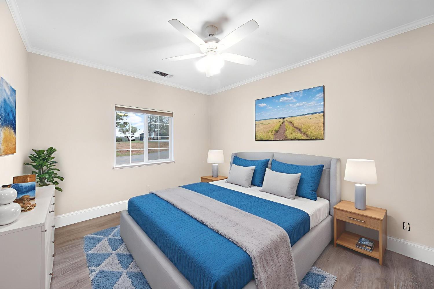 1261 Jurgens Road Rescue, CA 95672 - Photo 24 of 74 a bedroom with a large bed and a chandelier