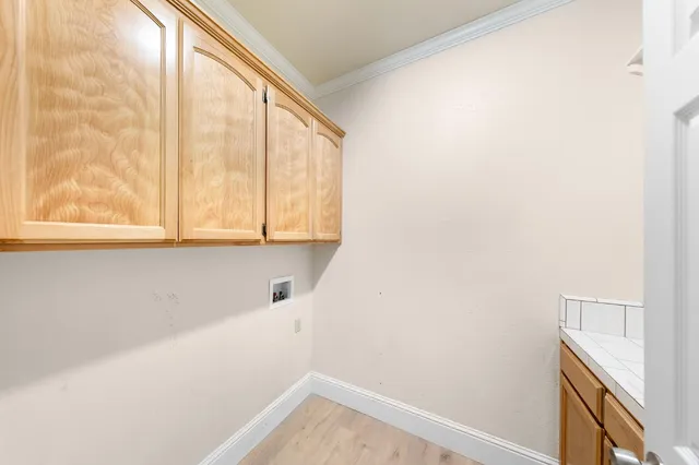 a kitchen with stainless steel appliances granite countertop a stove top oven a sink dishwasher and a fireplace with wooden floor