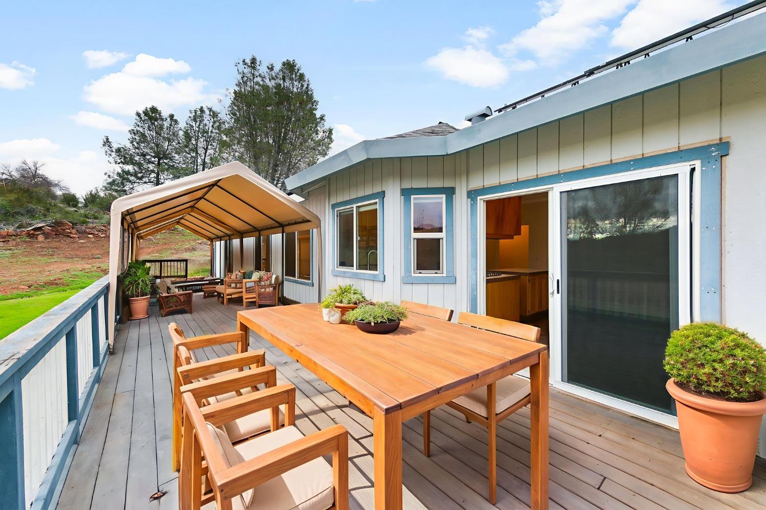 1261 Jurgens Road Rescue, CA 95672 - Photo 31 of 74 a view of a patio with table and chairs potted plants with wooden floor and fence