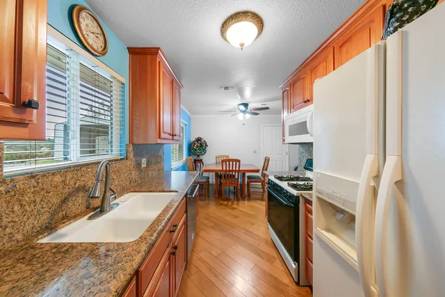a front view of a house with yard and green space