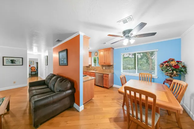 a view of a house with a yard and a street