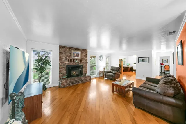 a view of a house with backyard and trees