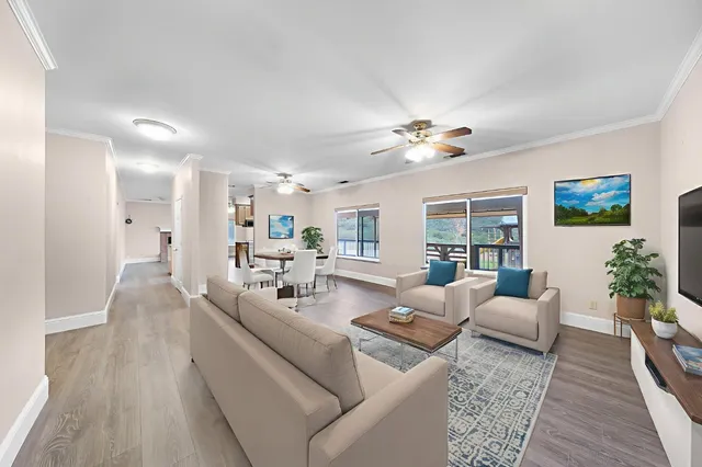 a kitchen with stainless steel appliances granite countertop a stove top oven a sink dishwasher and a fireplace with wooden floor