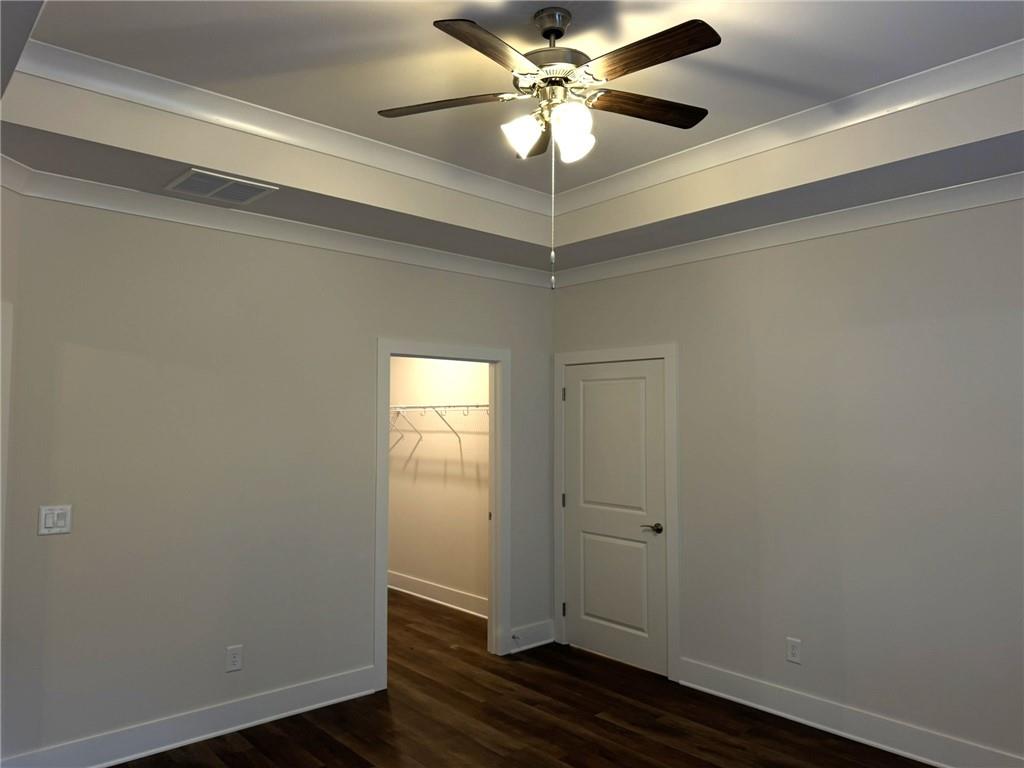 65 Village Court Cleveland, GA 30528 - Photo 11 of 21 an empty room with wooden floor closet and fan