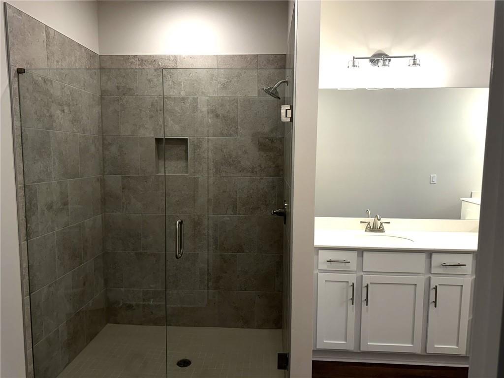 65 Village Court Cleveland, GA 30528 - Photo 12 of 21 a bathroom with a shower sink and mirror