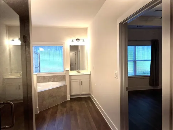 a view of a livingroom with a ceiling fan and window