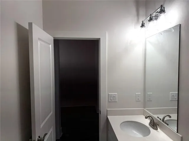 en empty room with wooden floor and windows