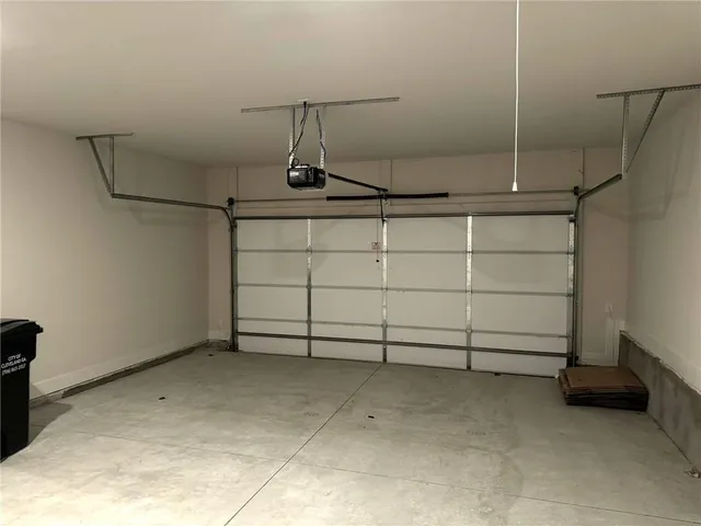 an empty room with wooden floor and ceiling fan