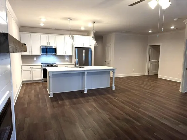a kitchen with a sink and chandelier