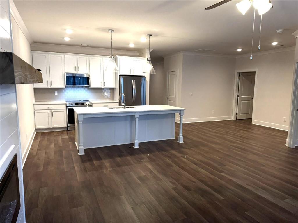 65 Village Court Cleveland, GA 30528 - Photo 3 of 21 a kitchen with stainless steel appliances granite countertop a sink a stove and a wooden floors