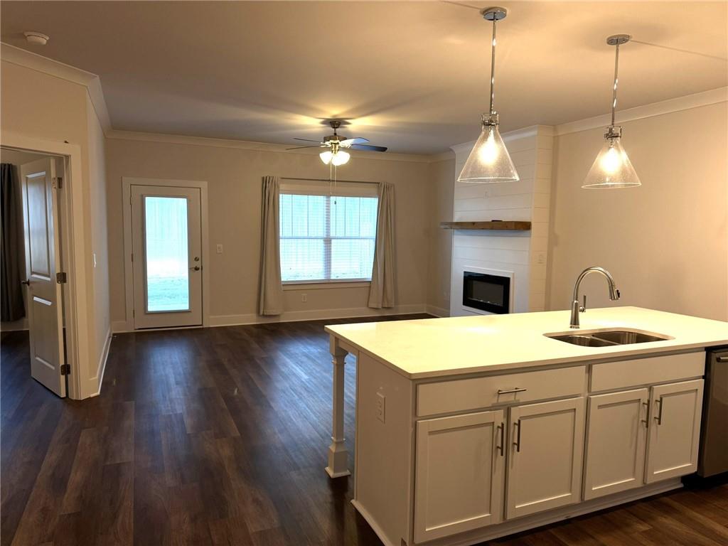 65 Village Court Cleveland, GA 30528 - Photo 4 of 21 a kitchen with a sink and chandelier