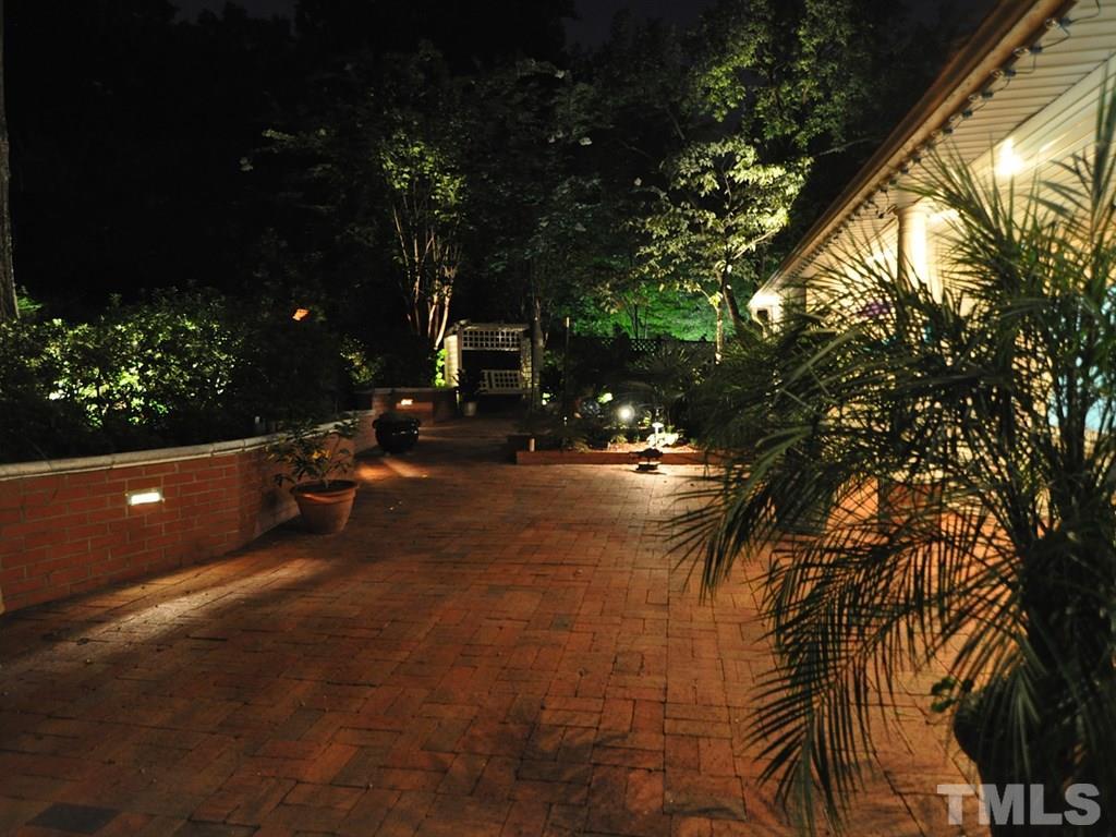 2025 St Marys Street Raleigh, NC 27608 - Photo 14 of 25 a backyard of a house with table and chairs and potted plants