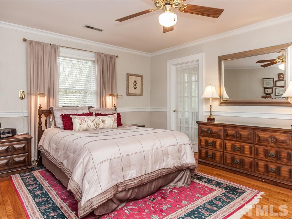 2025 St Marys Street Raleigh, NC 27608 - Photo 15 of 25 a bedroom with bed and wooden floor