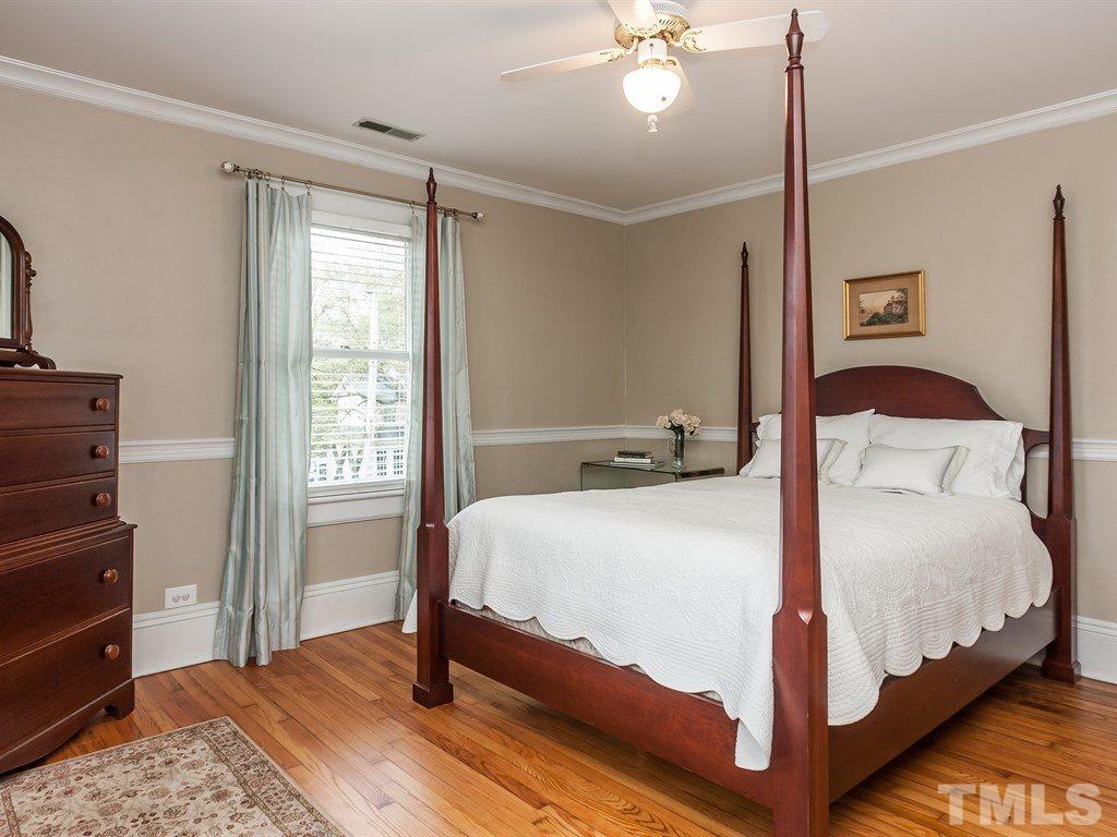 2025 St Marys Street Raleigh, NC 27608 - Photo 20 of 25 a bedroom with a bed lamp and dresser