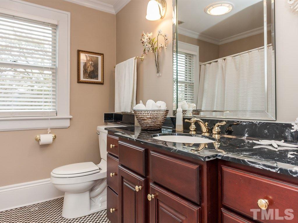 2025 St Marys Street Raleigh, NC 27608 - Photo 21 of 25 a bathroom with a granite countertop sink toilet and large mirror