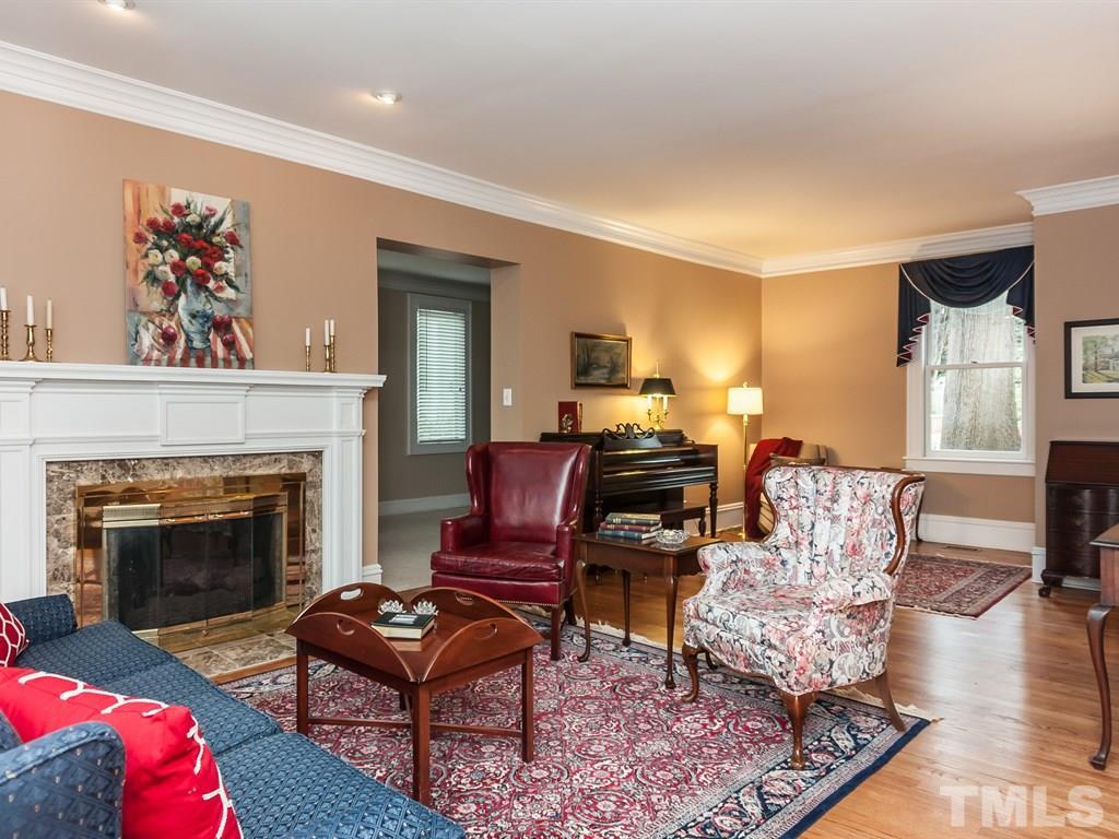 2025 St Marys Street Raleigh, NC 27608 - Photo 4 of 25 a living room with furniture and a fireplace