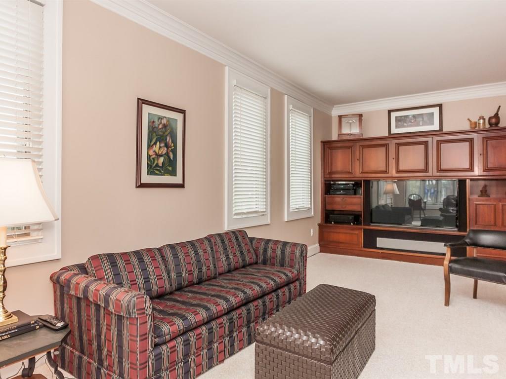 2025 St Marys Street Raleigh, NC 27608 - Photo 7 of 25 a living room with furniture and a book shelf