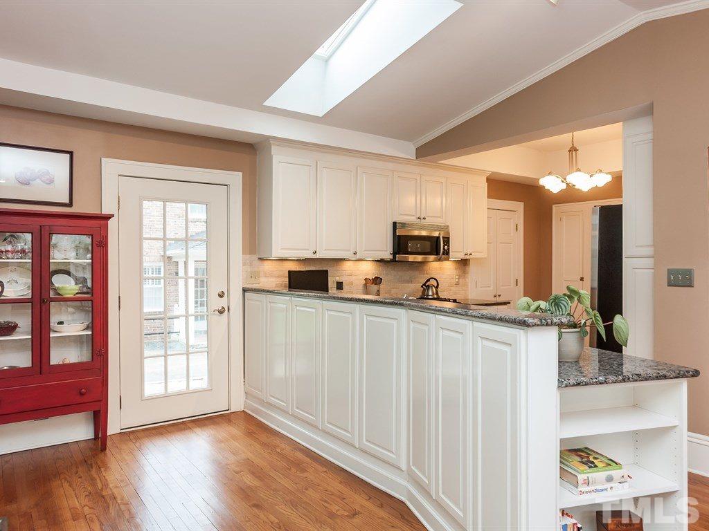 2025 St Marys Street Raleigh, NC 27608 - Photo 9 of 25 a kitchen with stainless steel appliances a microwave and cabinets