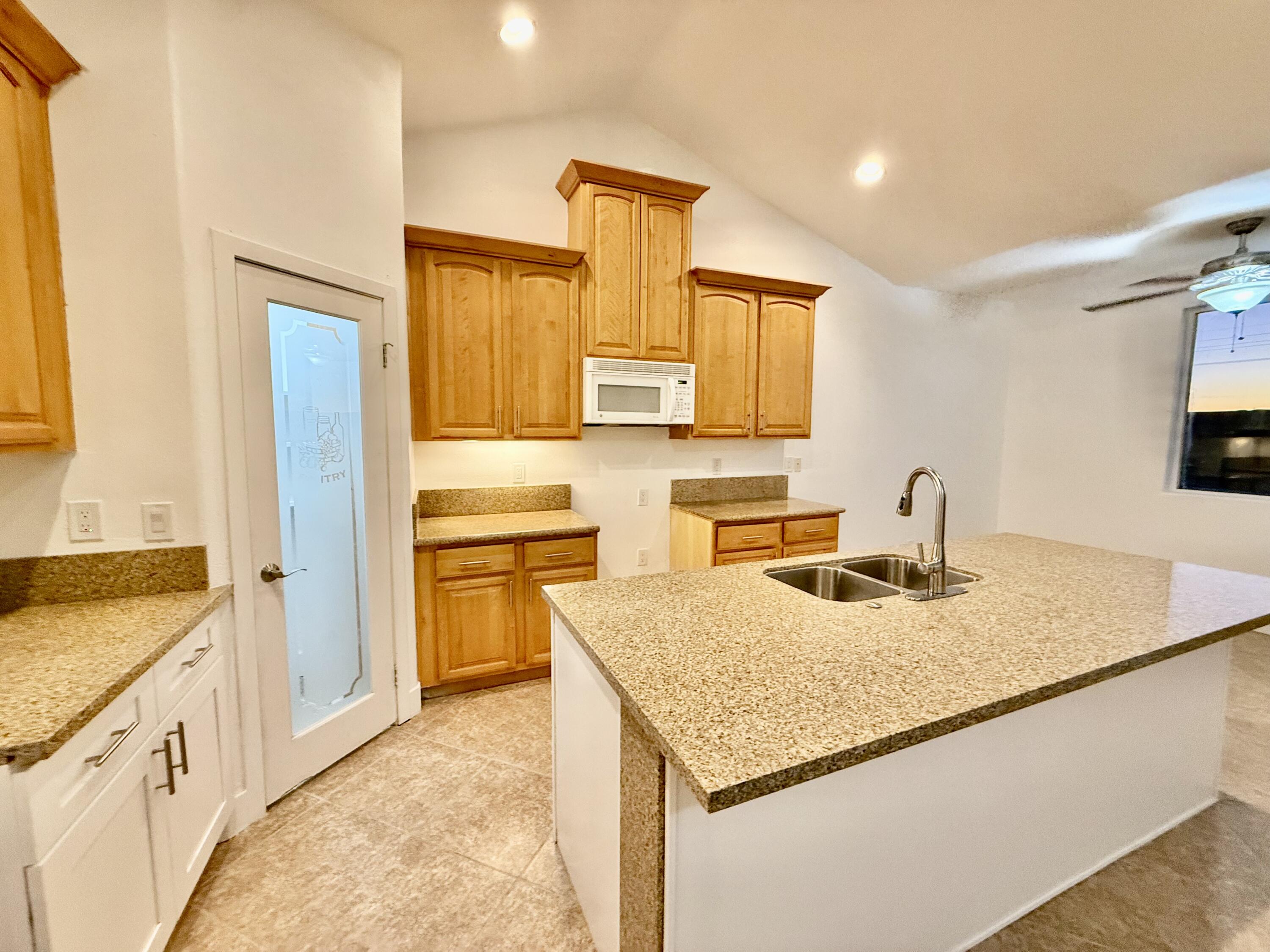 2283 Azure Avenue Thermal, CA 92274 - Photo 11 of 26 a kitchen with a stove a sink and a refrigerator