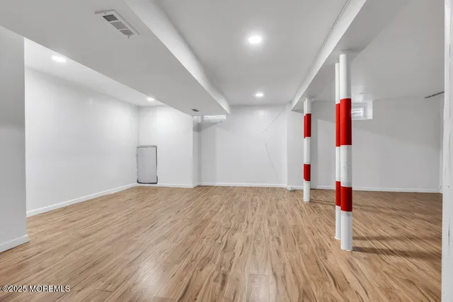 an empty room with wooden floor and traffic signal
