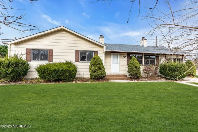 a front view of house with yard and green space