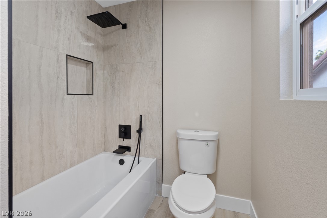 1662 Ravanusa Drive Henderson, NV 89052 - Photo 32 of 74 A well-appointed bathroom with contemporary fixtures, including a deep soaking tub and sleek tilework.