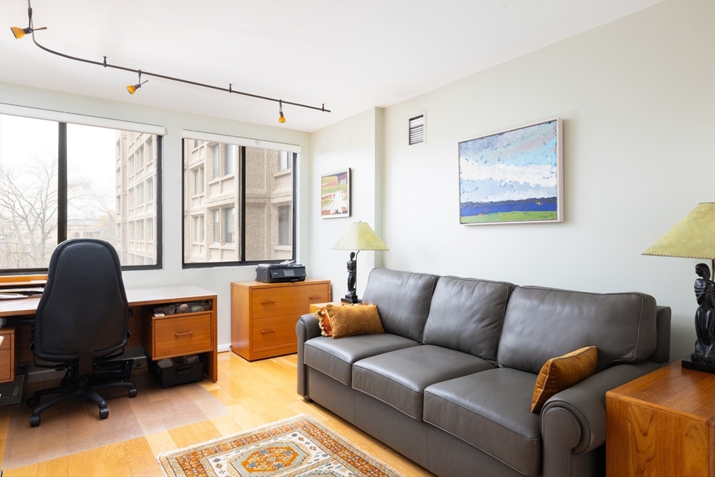 1731 Beacon Street, Unit 402 Brookline, MA 02445 - Photo 7 of 14 a living room with furniture and a large window