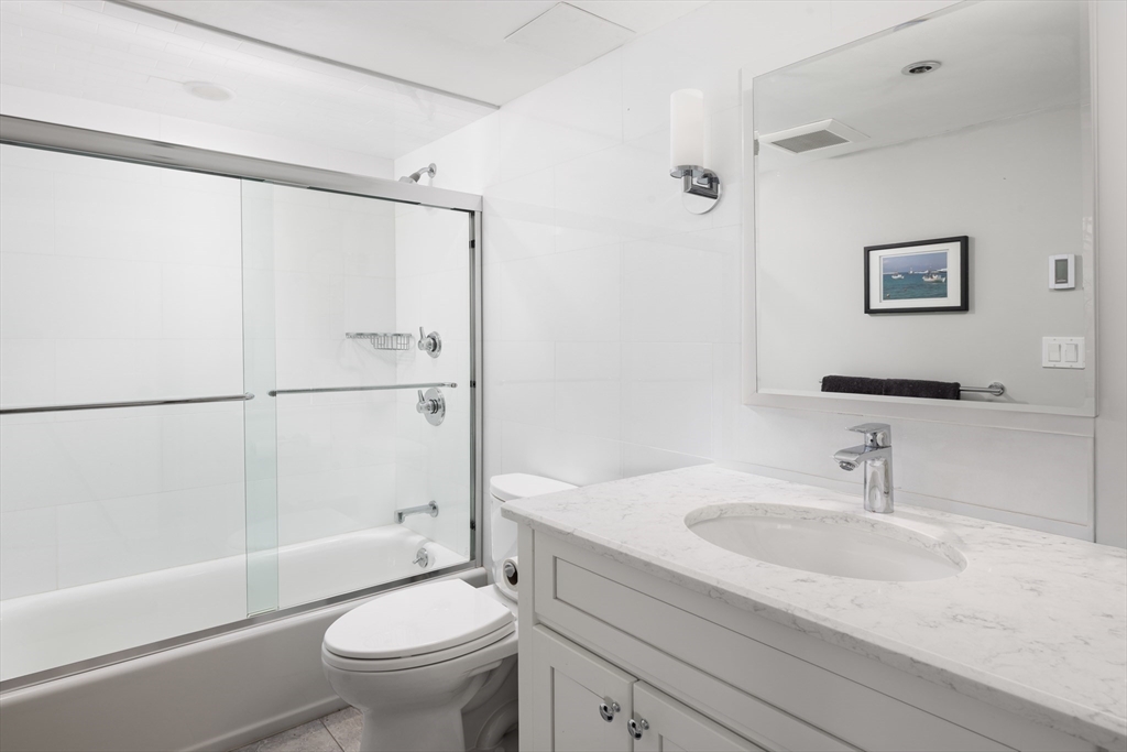 1731 Beacon Street, Unit 402 Brookline, MA 02445 - Photo 10 of 14 a bathroom with a sink toilet and shower