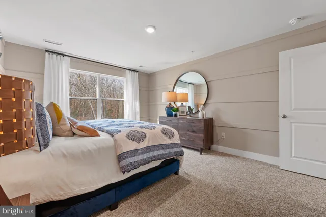 a bedroom with bed and a large window