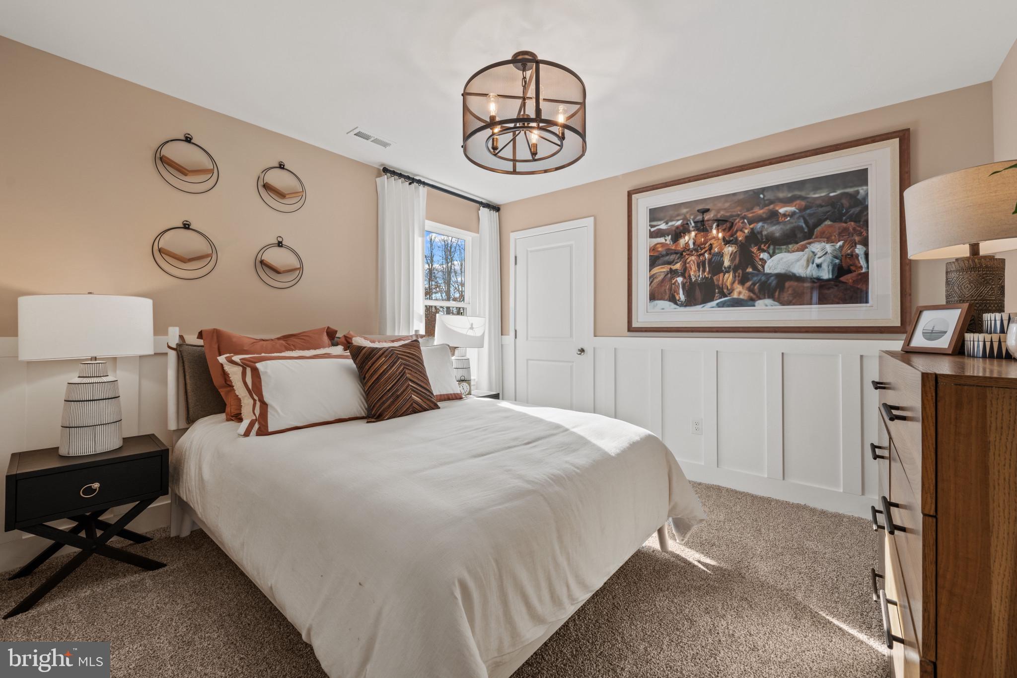 372 Eclipse Street Ranson, WV 25438 - Photo 24 of 34 a bedroom with a large bed and a chandelier