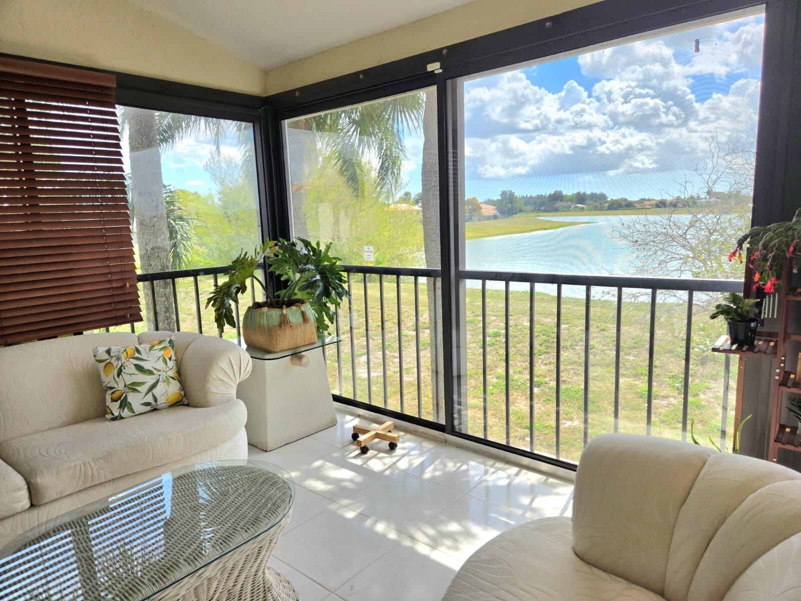 10870 Lakemore Lane, Unit 201 Boca Raton, FL 33498 - Photo 11 of 26 a living room with furniture and a large window