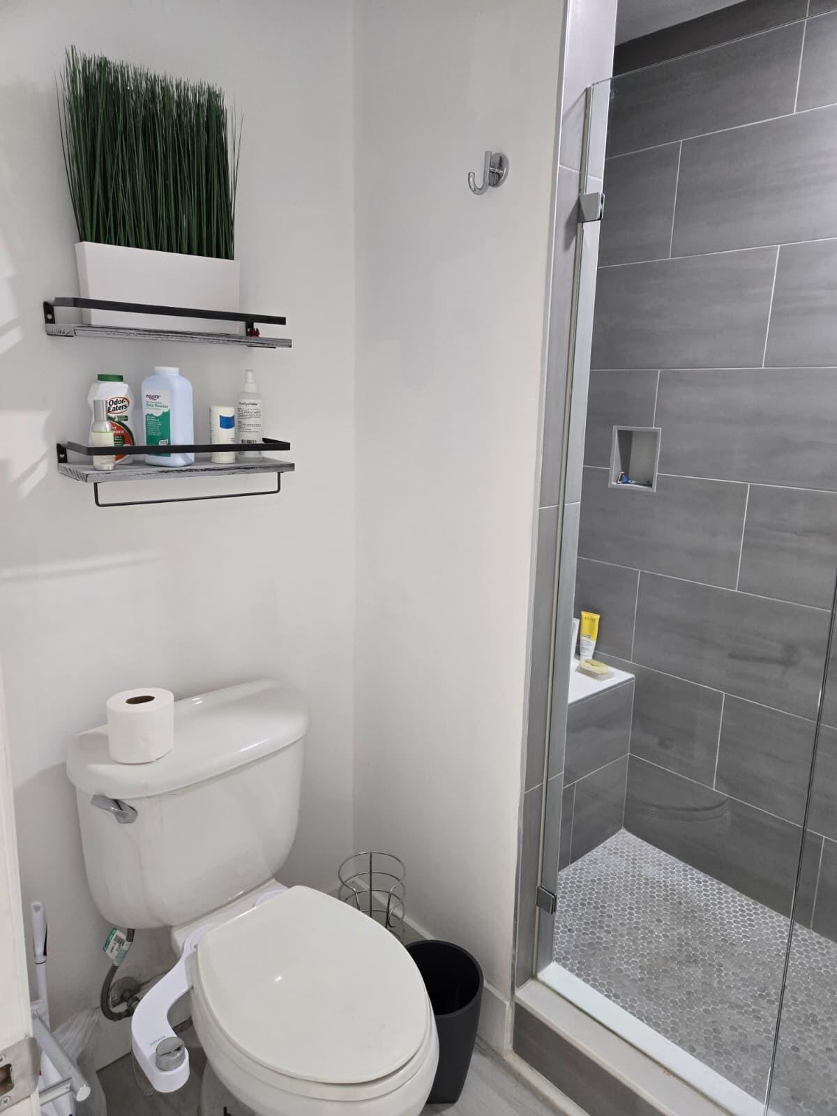 10870 Lakemore Lane, Unit 201 Boca Raton, FL 33498 - Photo 14 of 26 a white toilet sitting next to a bathroom sink and vanity