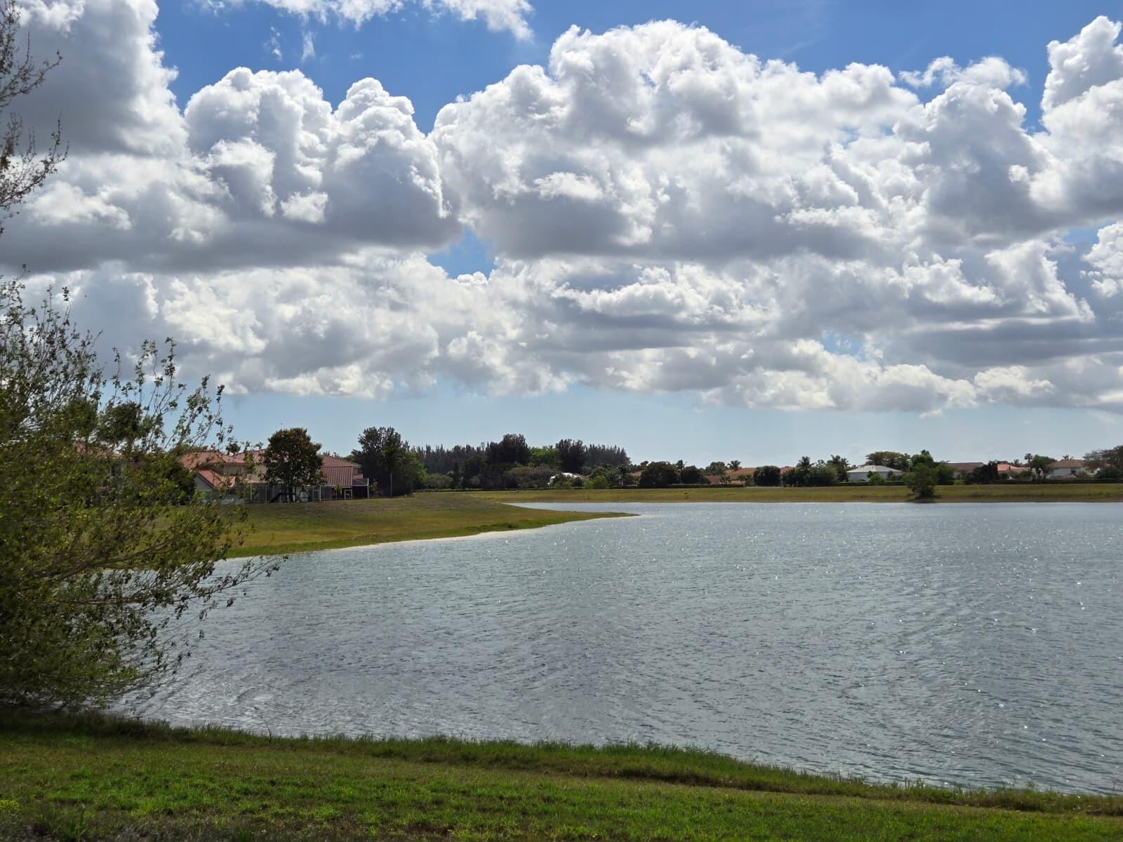 10870 Lakemore Lane, Unit 201 Boca Raton, FL 33498 - Photo 10 of 26 a view of a lake and a yard