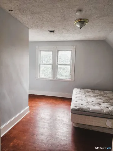 a bedroom with a bed and window