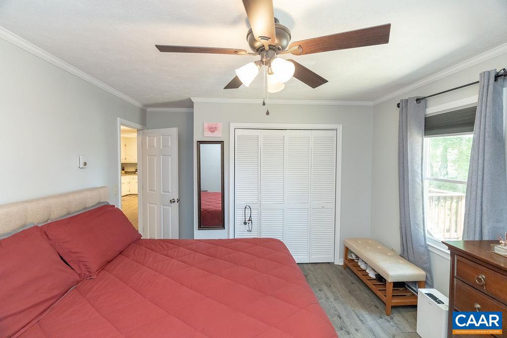 6920 Albevanna Spring Road Scottsville, VA 24590 - Photo 25 of 47 a bedroom with a bed and a chandelier