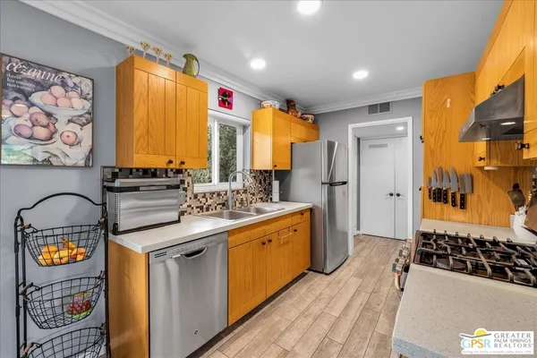 a kitchen with stainless steel appliances granite countertop a stove and a refrigerator