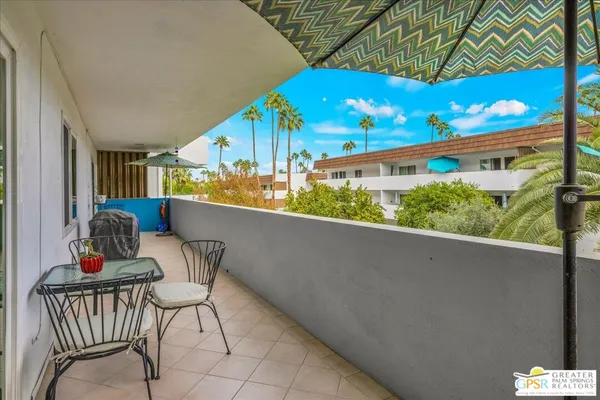a view of a chairs and table in a balcony